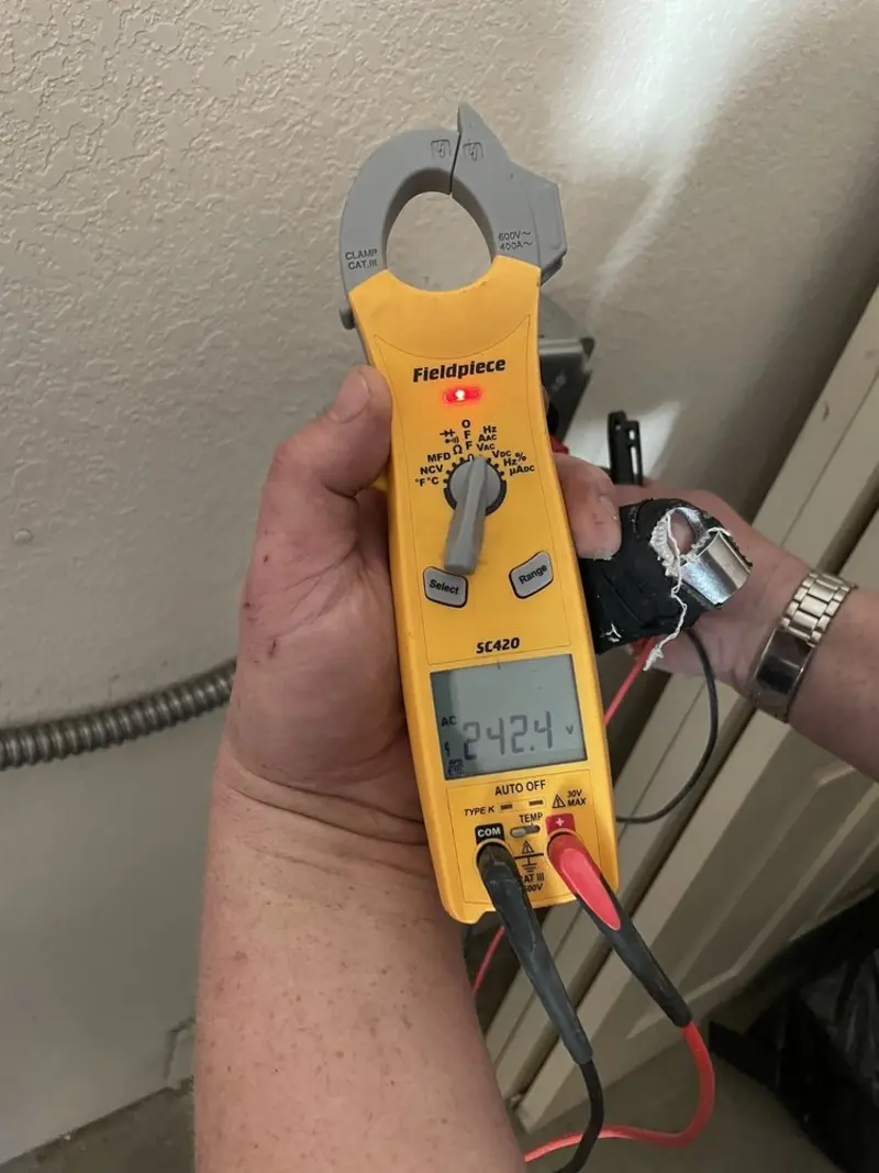 Voltage testing with clamp meter during Recessed Lighting Installation in Harrisonville
